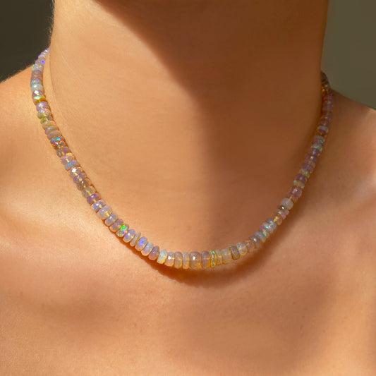 Shimmering beaded necklace made of faceted opals in shades of clear and light yellow on a gold linking ovals clasp. 