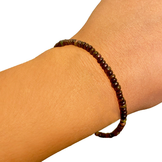 Shimmering beaded bracelet made of smooth opals in shades of brown on a gold linking lobster clasp.