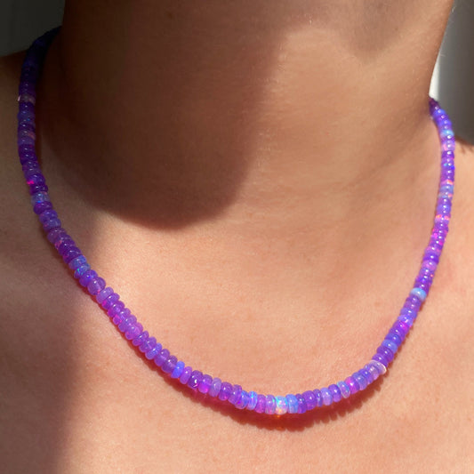 Shimmering beaded necklace made of smooth opal rondels in shades of violet on a slim gold oval clasp.