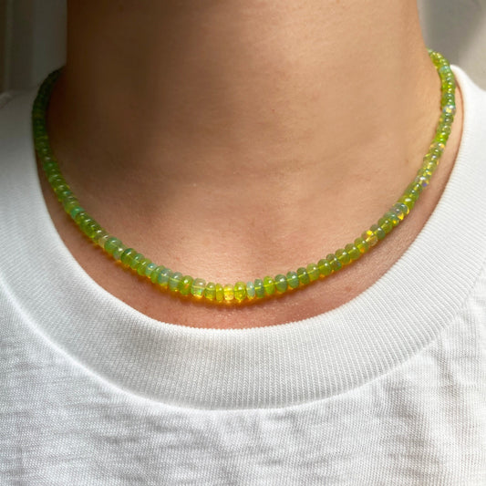 Shimmering beaded necklace made of smooth opal rondels in shades of yellow-green on a slim gold lobster clasp. 