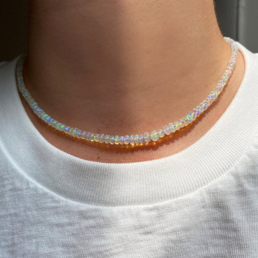 Shimmering beaded necklace made of smooth opal rondels in shades of clear opals on a slim gold lobster clasp.