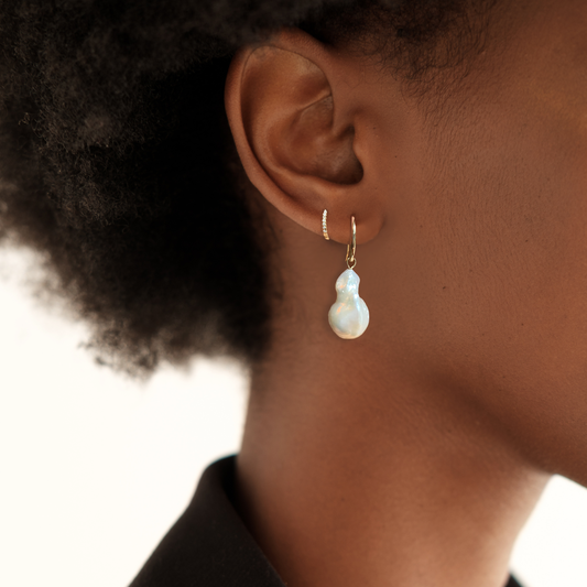 14k gold Baroque Pearl Drop Earring styled on a ear