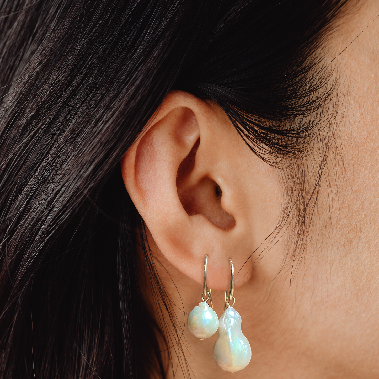 14k gold Baroque Pearl Drop Earrings styled on a ear