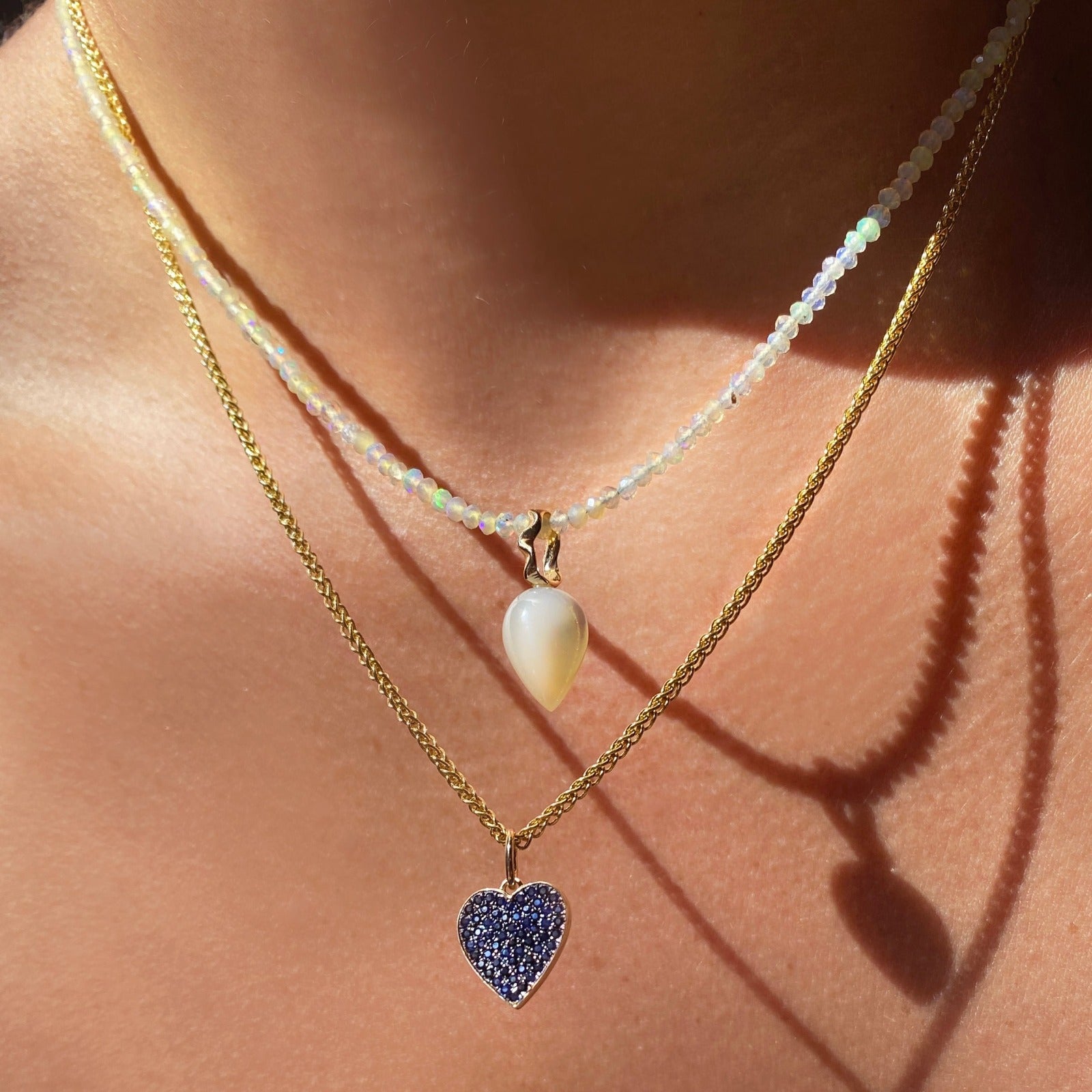 14k gold Wheat Chain Necklace. Styled on a neck with a pave medium heart charm