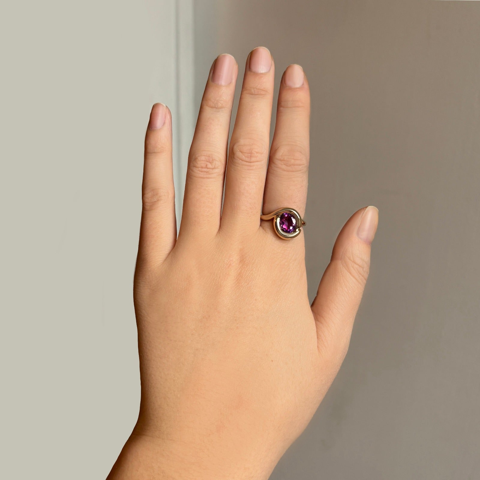 14k gold Molten Knot Ring styled on a hand - Amethyst