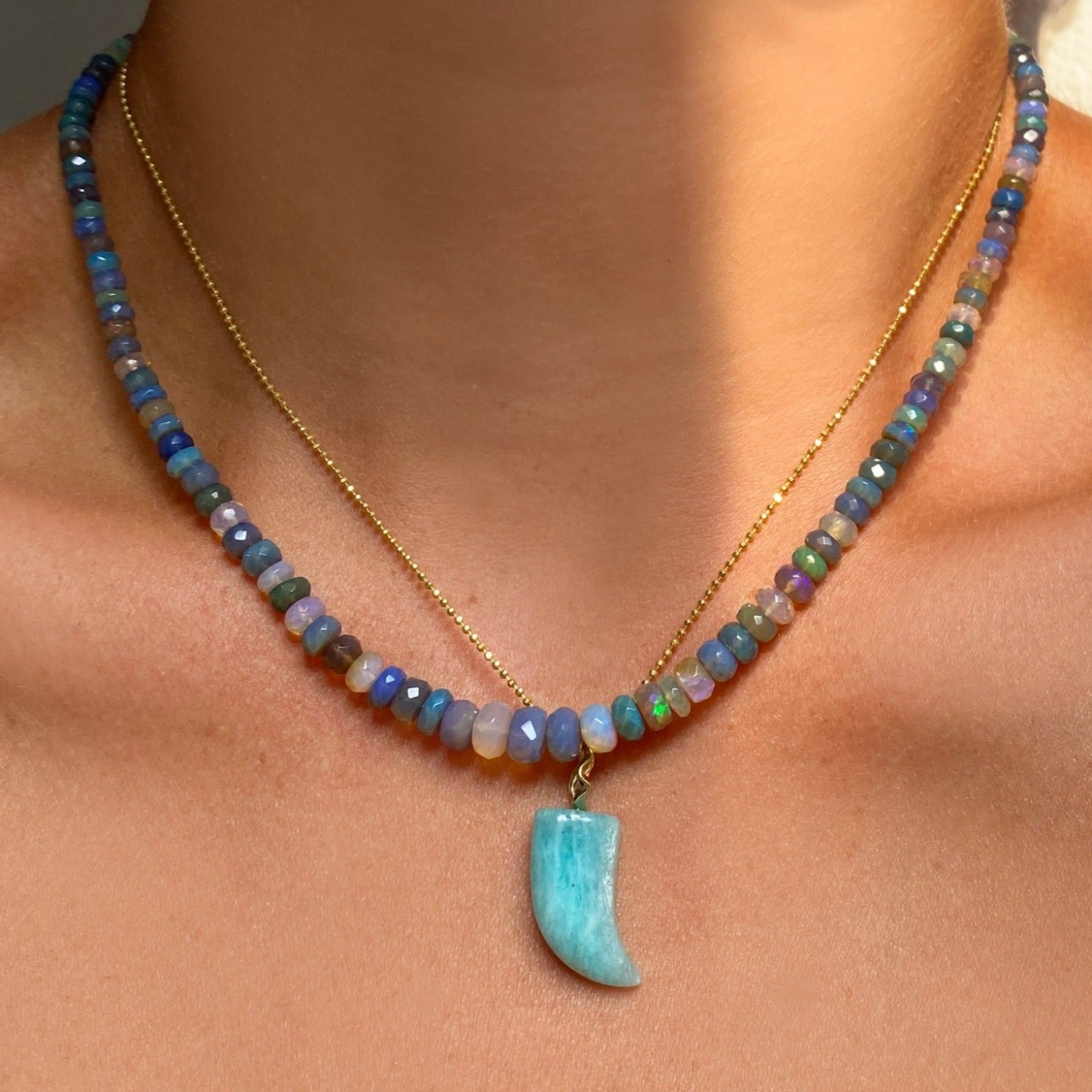 Amazonite horn charm. Styled on a neck hanging from a diamond cut bead chain necklace.
