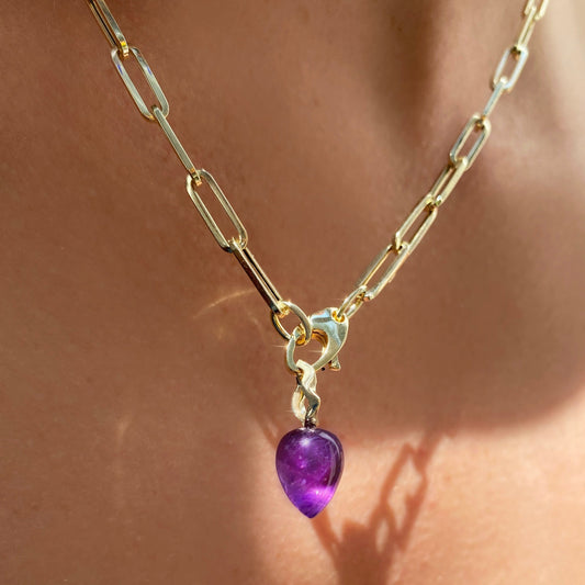 Amethyst acorn drop charm. Styled on a neck hanging from the lobster clasp of a chunky paperclip chain necklace