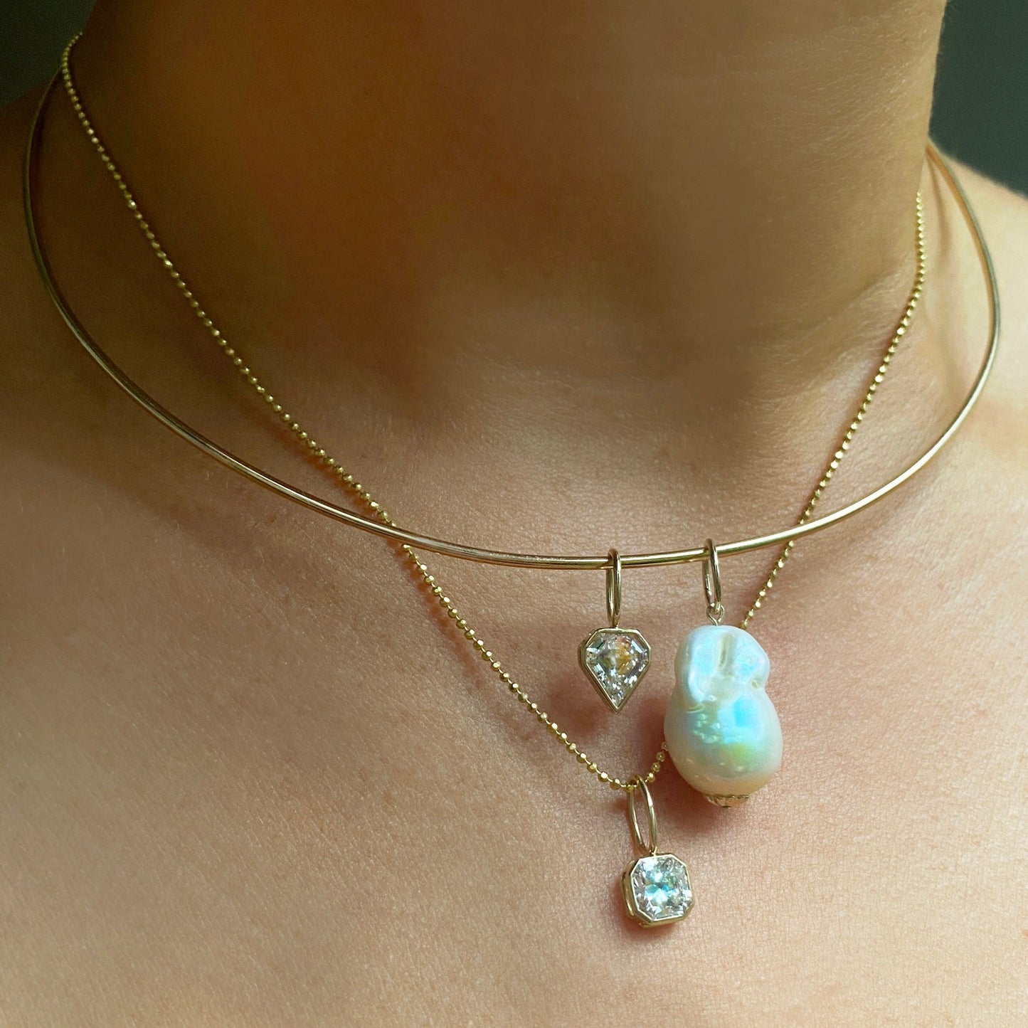 Baroque Pearl Charm. Styled on a neck with a solitaire hanging from a wire choker necklace