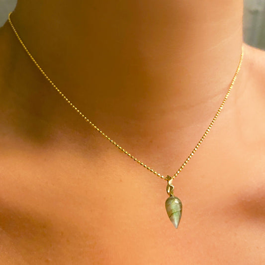 Labradorite acorn drop charm. Styled on a neck hanging from a diamond cut bead chain necklace.