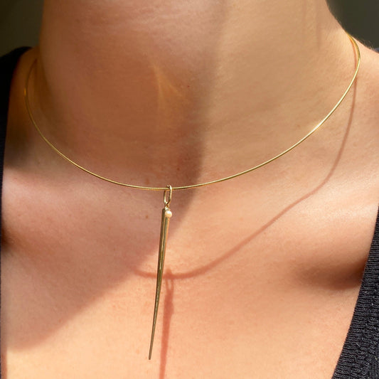 14k gold Omega Choker Necklace styled on a neck with a quill spike charm