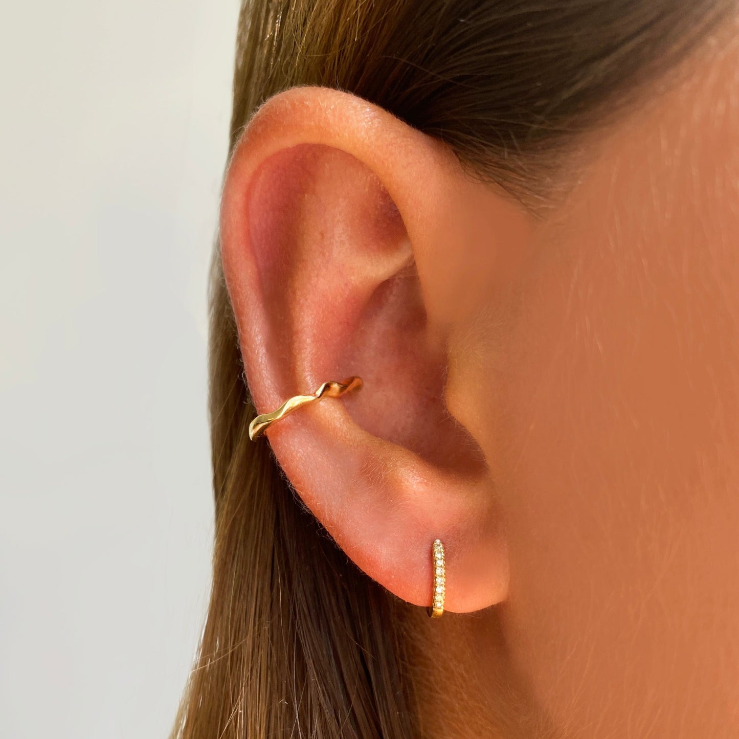 14k gold Ripple Midi Ear Cuff styled on a ear