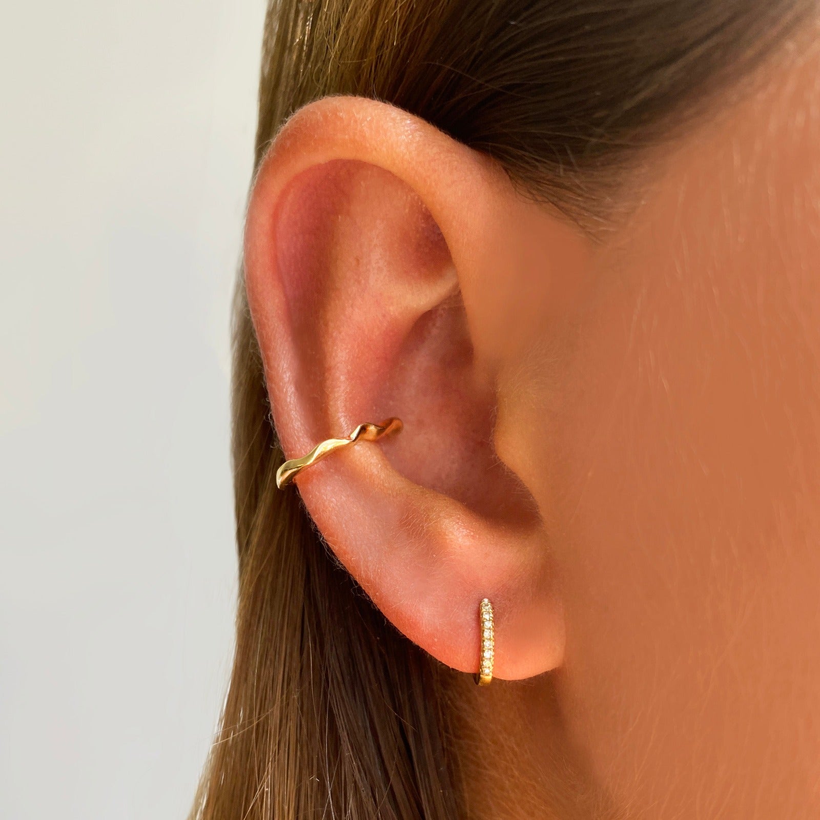 14k gold Ripple Midi Ear Cuff styled on a ear