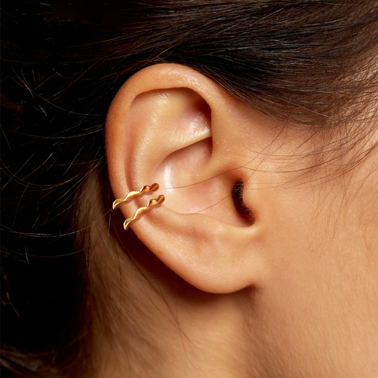 14k gold Ripple Midi Ear Cuffs styled on a ear