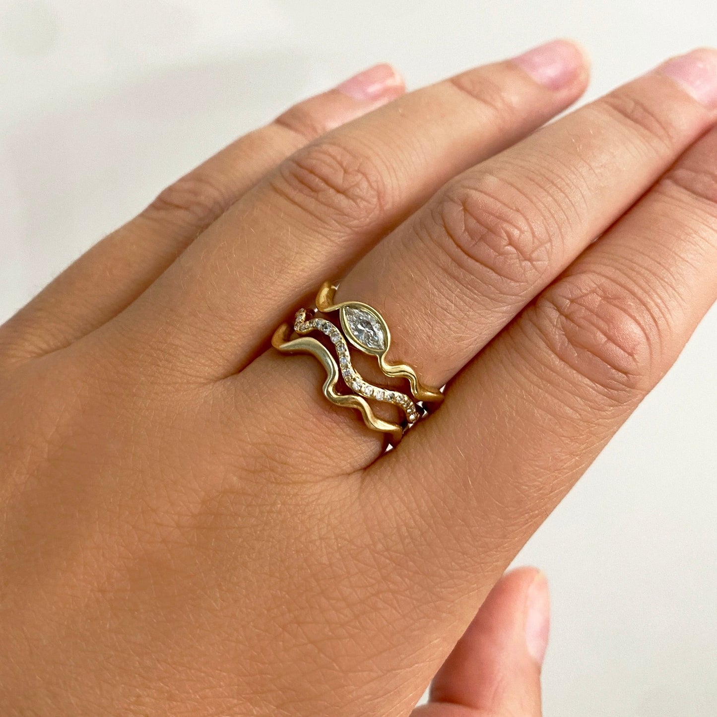 14k gold Ripple Ring with Marquise Diamond styled on a hand