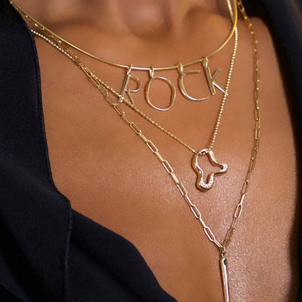14k gold Demi Pavé Ripple Charm. Styled on a neck hanging from a diamond cut bead necklace.