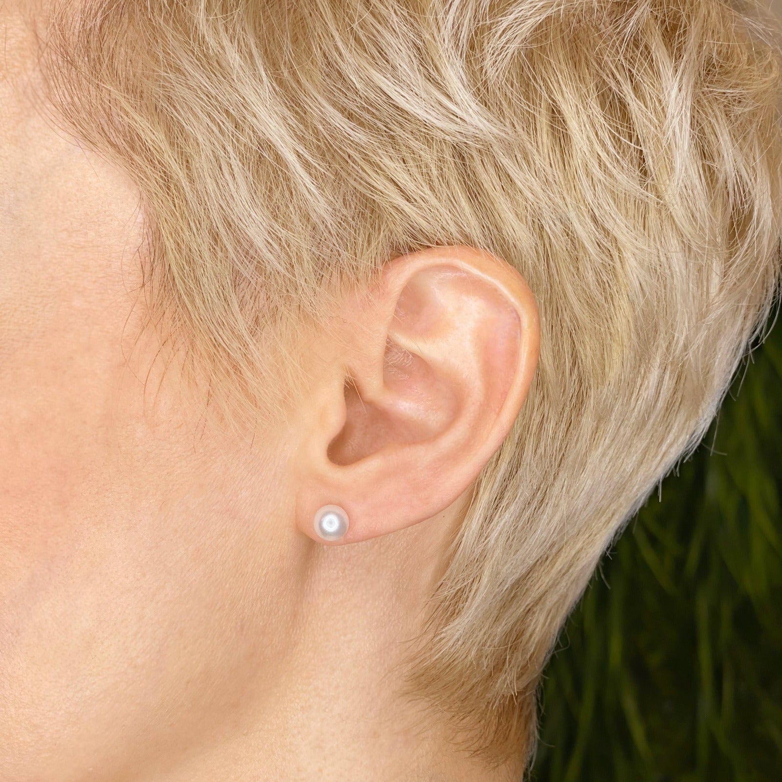 14k white gold White Pearl Stud Earring styled on a ear