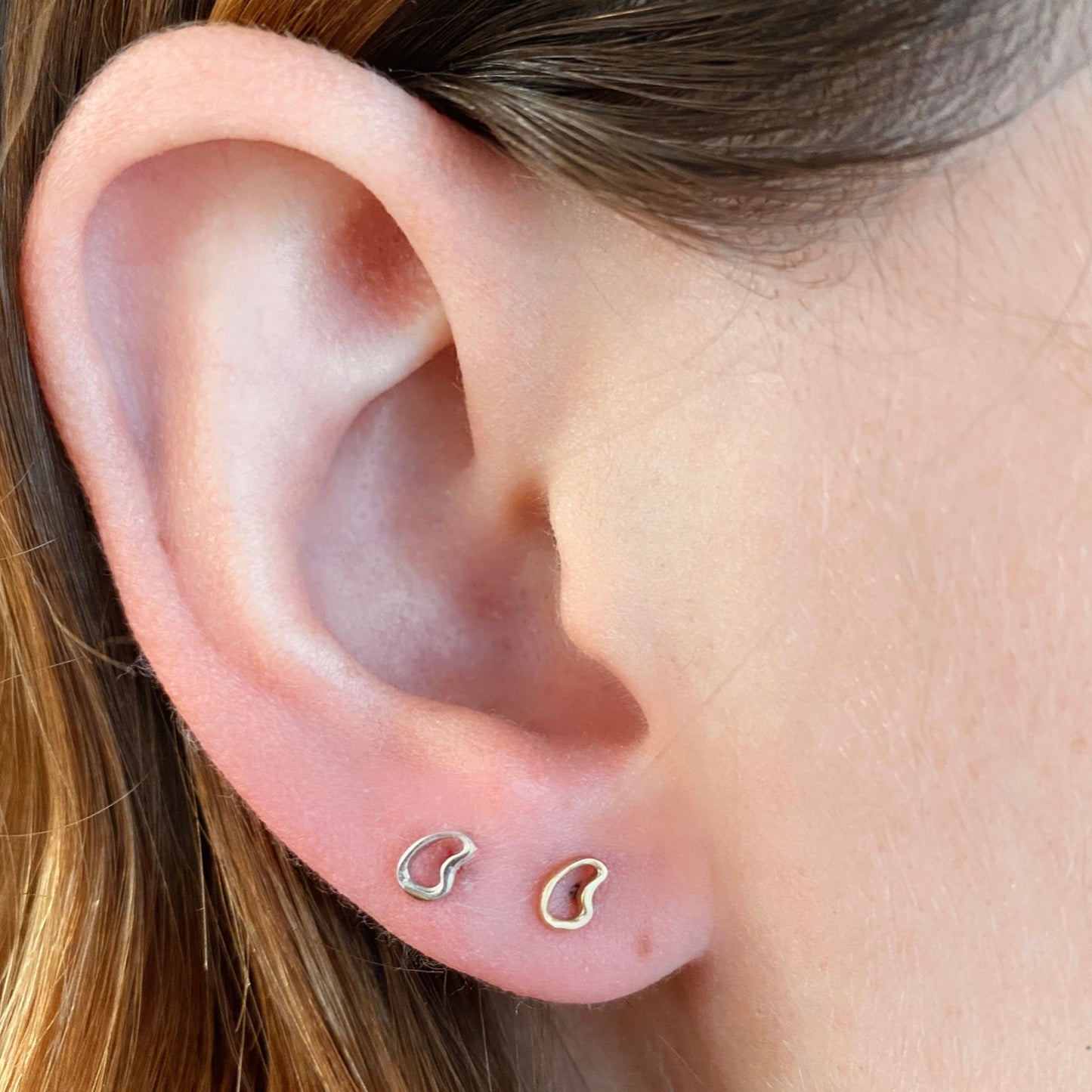 14k Plain Small Ripple Stud Earrings styled on a ear