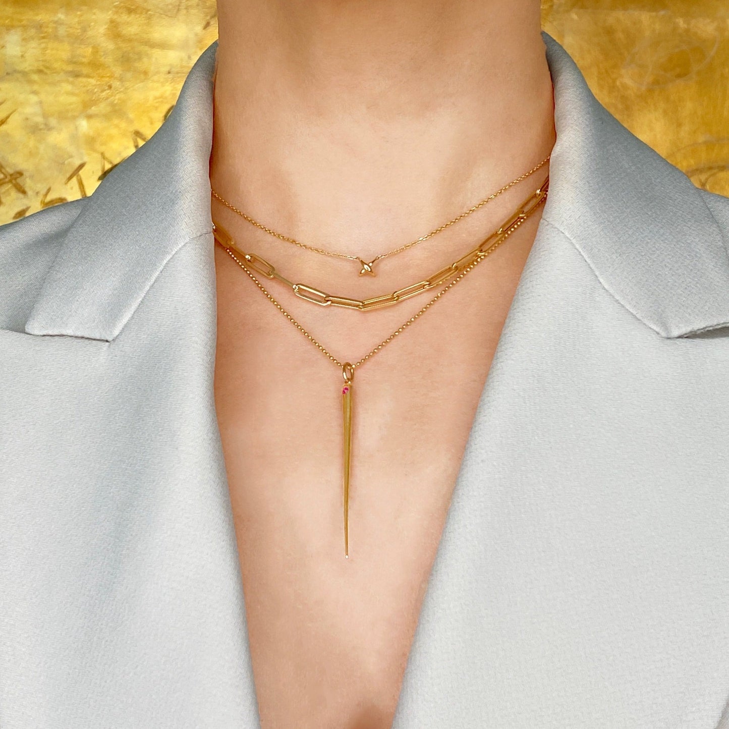 14k gold Stitch Necklace styled on a neck