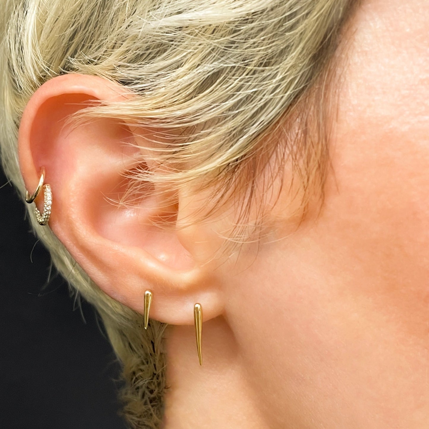 14k gold Quill Spike Studs styled on a ear