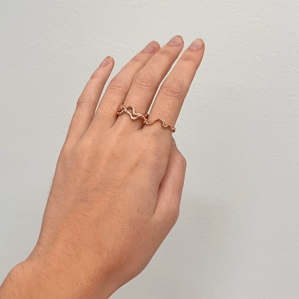 14k gold Double Finger Ripple Ring styled on a hand gif