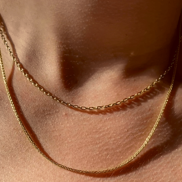 14k gold Wheat Chain Necklace. Styled on a neck shimmering gif