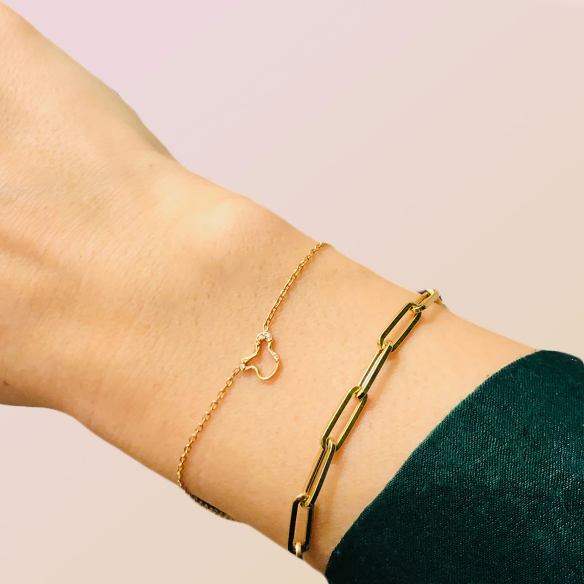 14k gold Chunky Paperclip Chain Bracelet with a lobster clasp styled on a wrist with a ripple chain bracelet.