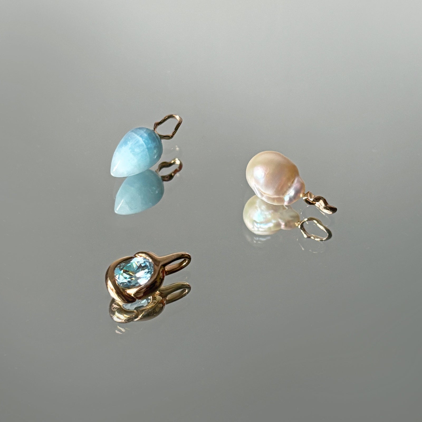 Ripple rings with small, marquise cut colored gemstones.