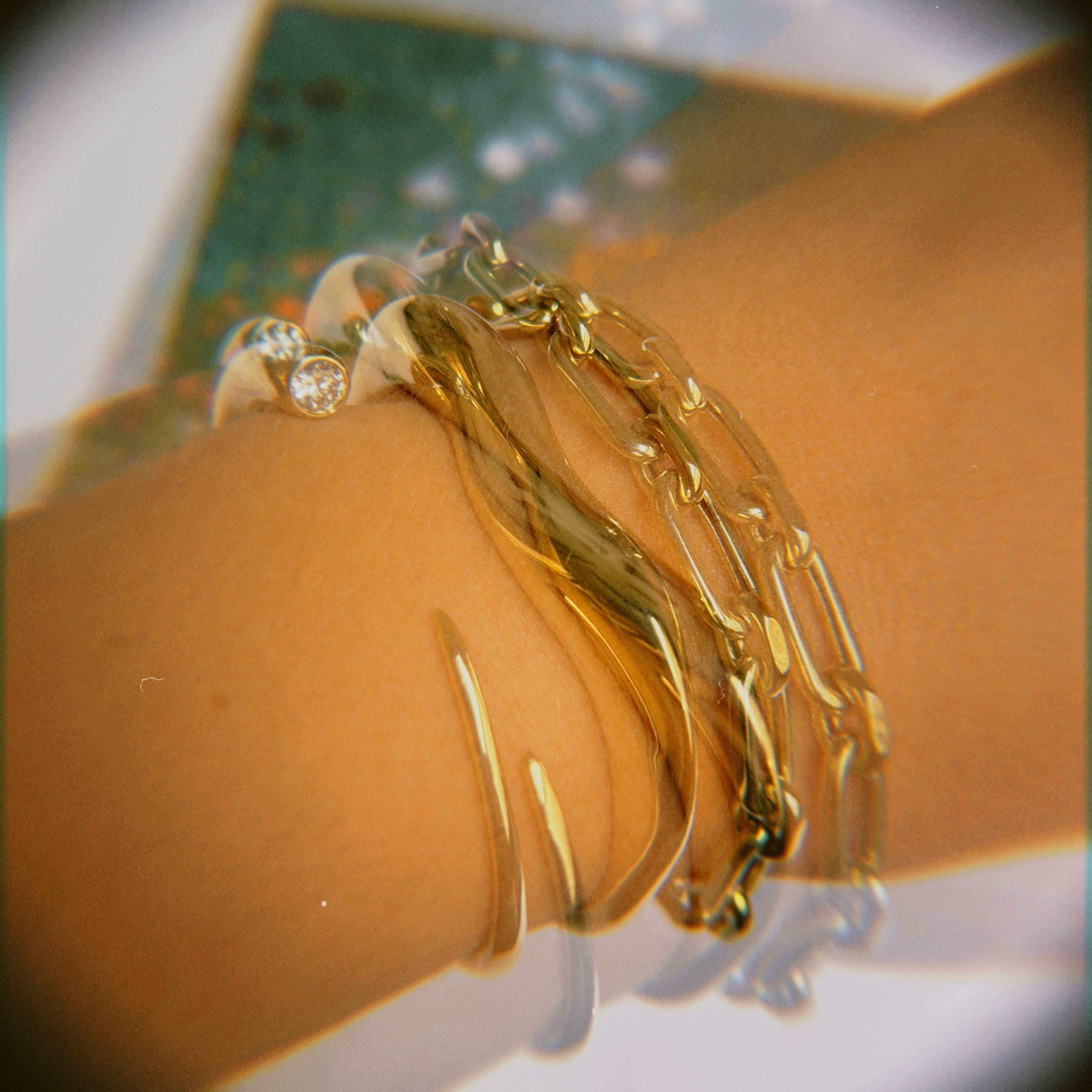 Bracelets and Anklets: Full Pavé 14K gold ripple cuffs styled on a wrist with quill bypass rings and ripple rings