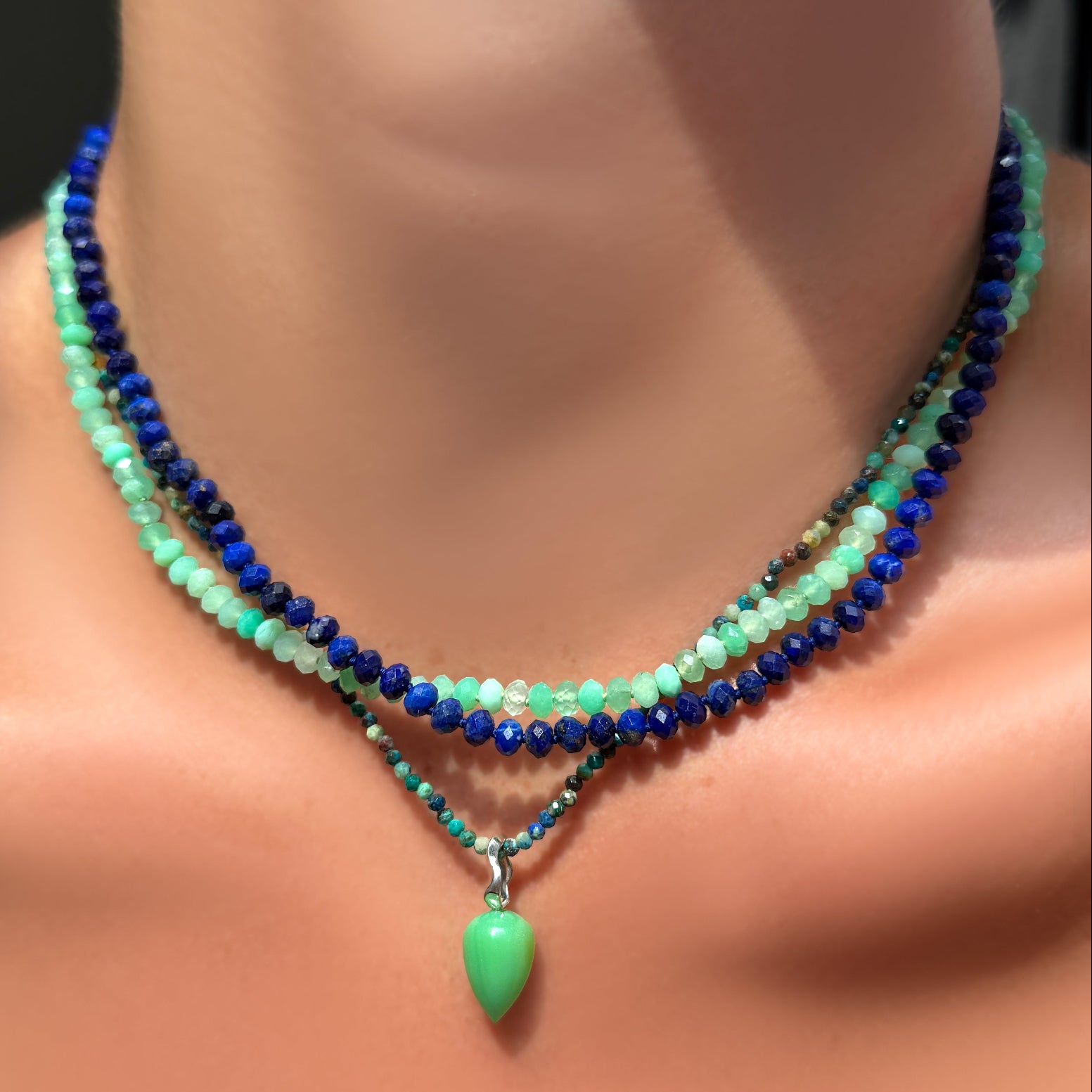 AMANDA PEARL Faceted Chrysoprase and Lapis Necklaces on Sterling Silver Evolution Clasp on a model's neck layered over a chrysocolla necklace with chrysoprase drop charm.