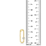 A 14K YG paperclip charm is displayed on a white background with a ruler next to it for scale. It demonstrates that the charm lock is 25mm in height. The charm lock features a small white diamond which sparkles.