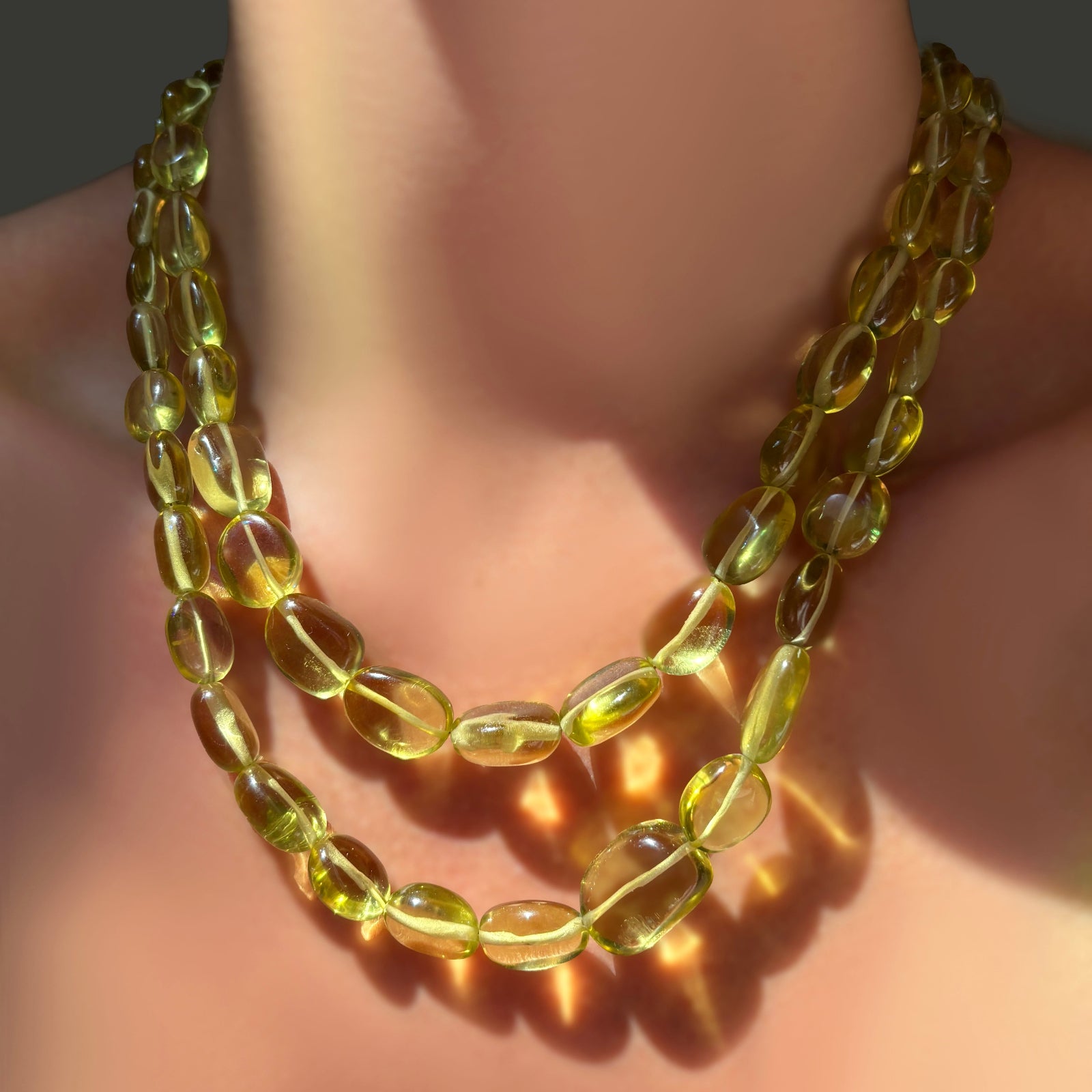 Two AMANDA PEARL Yellow Topaz Nugget Necklaces layered on a model's neck.