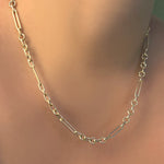 Chunky irregular cable chain necklace on a model's neck.
