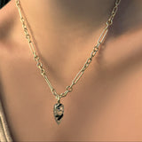 6mm irregular cable chain in yellow gold with a rutilated quartz gemstone drop charm on a model's neck.
