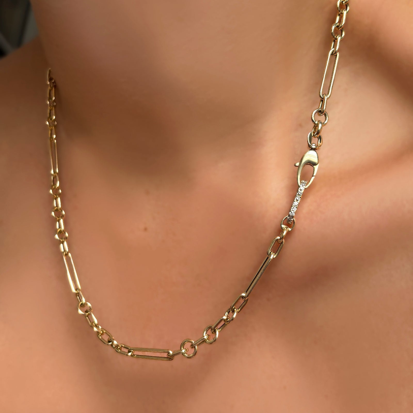 6mm irregular cable chain with small diamond charm lock on a model's neck.
