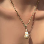 6mm irregular cable chain with baroque pearl charm on a model's neck.