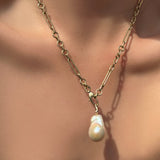 6mm irregular cable chain with baroque pearl charm on a model's neck.