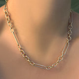 Chunky irregular cable chain necklace on a model's neck.