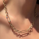 8mm irregular cable chain with a paperclip chain with sapphire attached in between the clasp on a model's neck.
