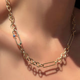 8mm irregular cable chain with a paperclip chain with sapphire attached in between the clasp on a model's neck.