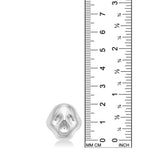 AMANDA PEARL Molten Skull Ring in recycled sterling silver on a white background next to a ruler.