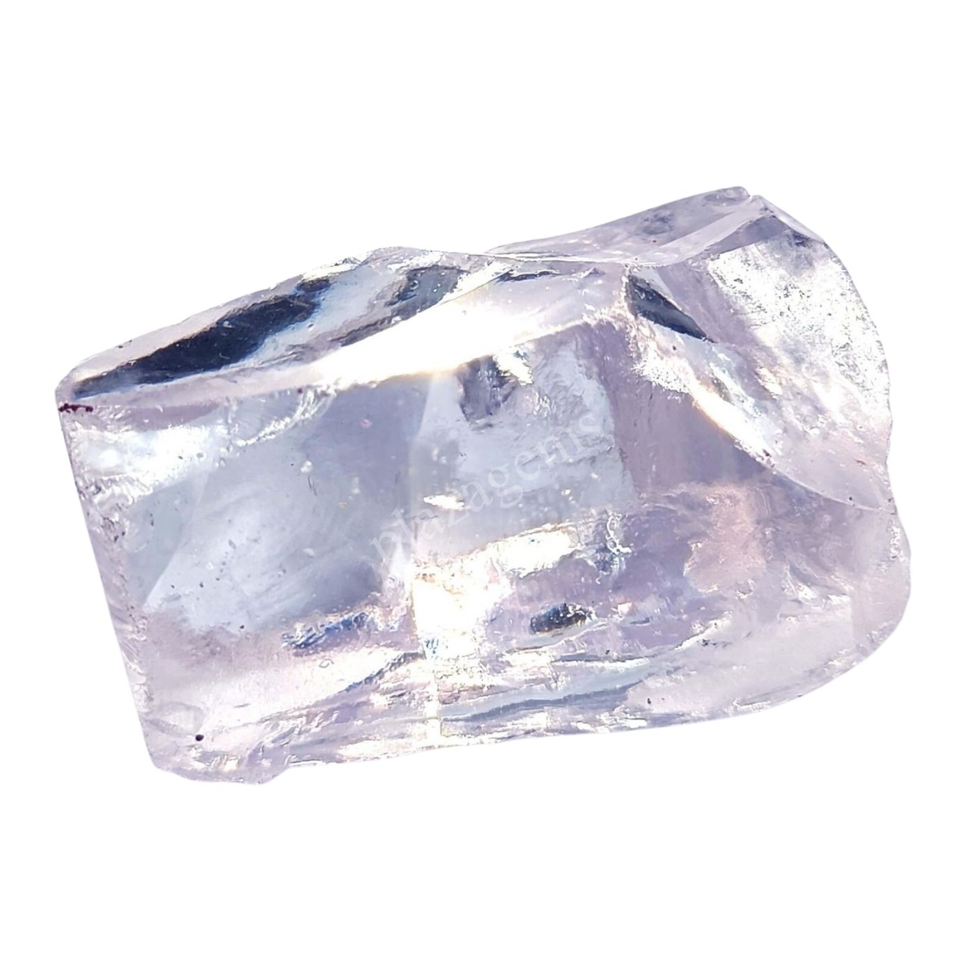 A raw white zircon stone on a white background.