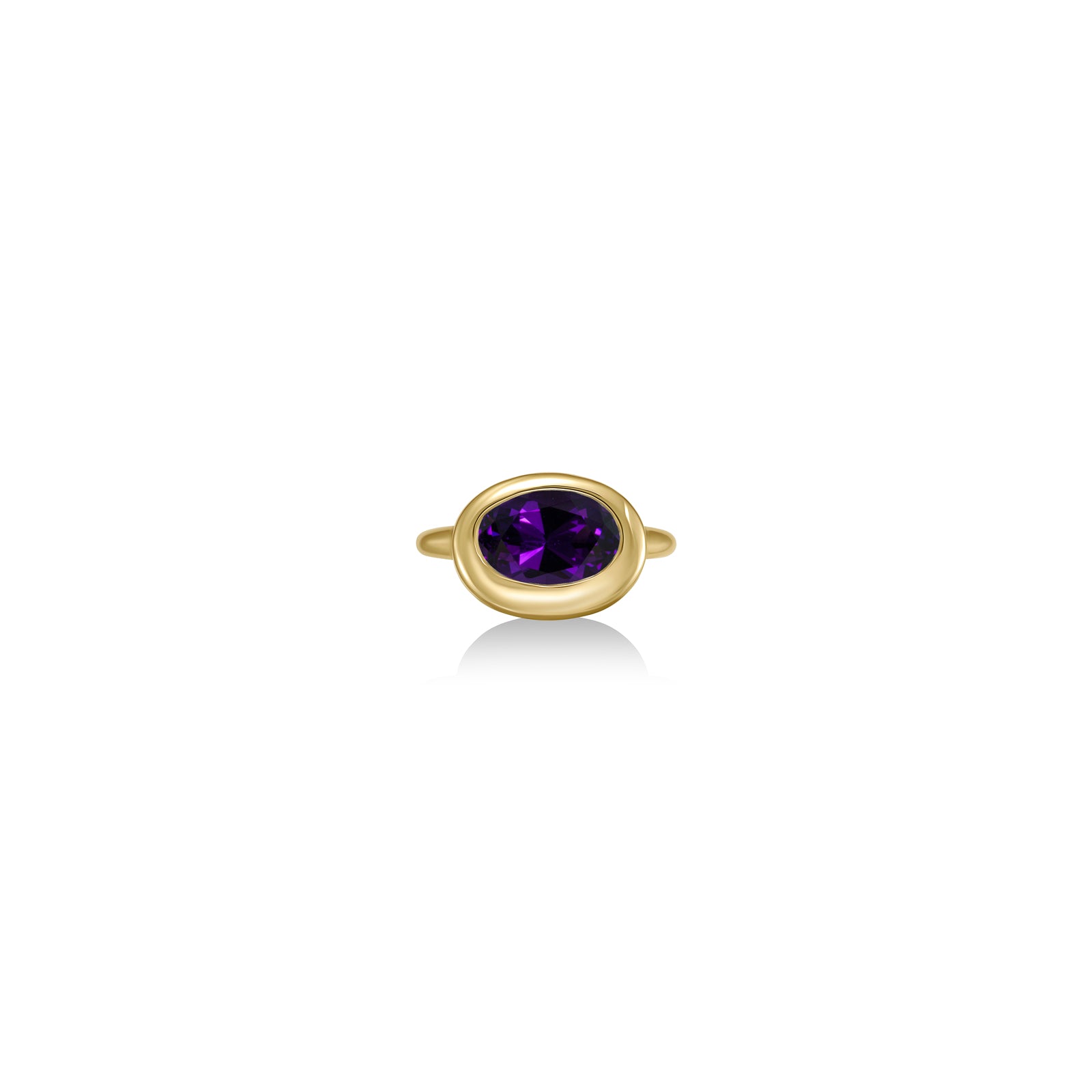 A 14K yellow gold oval ring, with a bezel set faceted amethyst gemstone, sits on a white background with drop shadow.