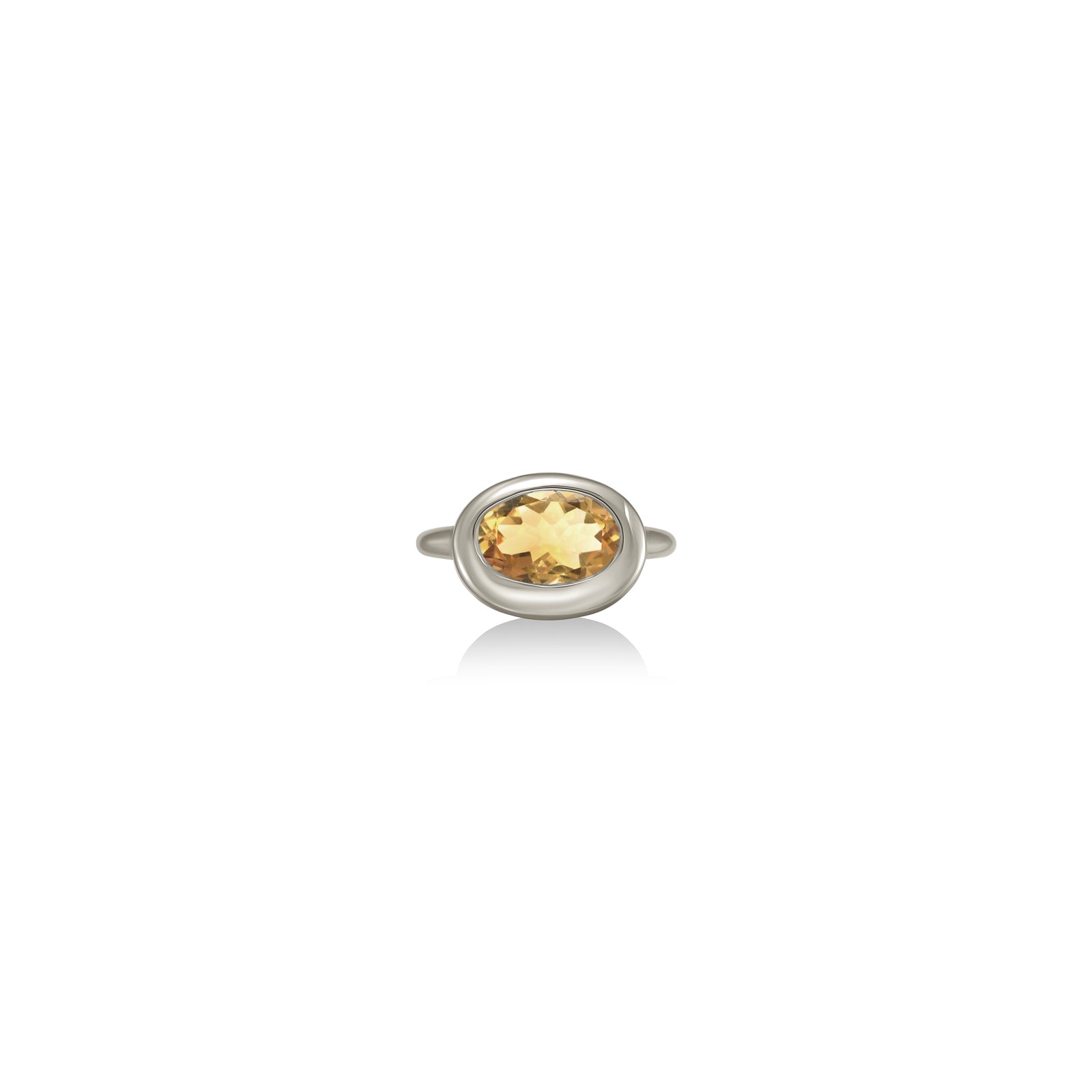 A 14K white gold oval ring, with a bezel set faceted citrine gemstone, sits on a white background with drop shadow.