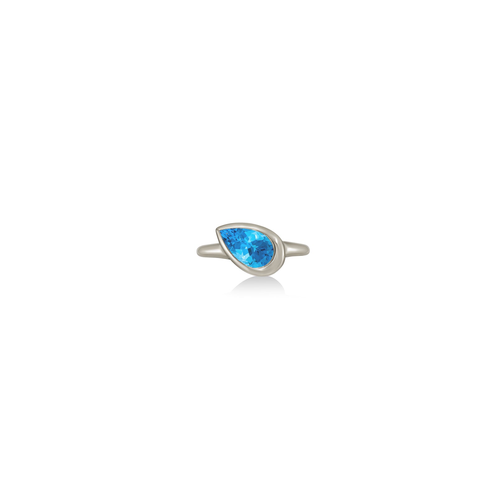 A 14K white gold pear shaped ring, with a bezel set faceted blue topaz gemstone, sits on a white background with drop shadow.