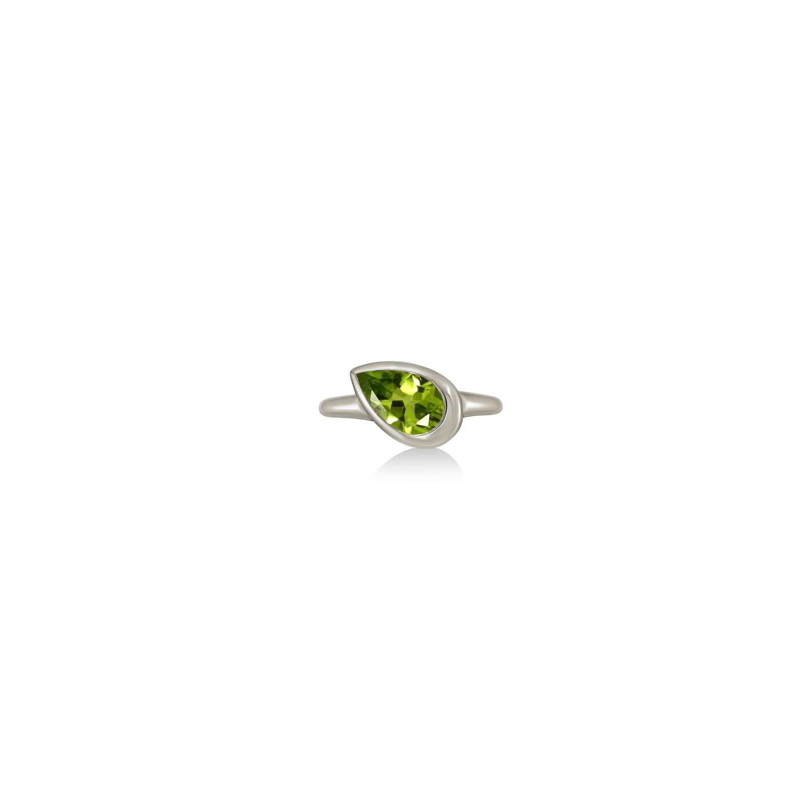 A 14K white gold pear shaped ring, with a bezel set faceted peridot gemstone, sits on a white background with drop shadow.