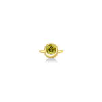 A 14K yellow gold round ring, with a bezel set faceted green tourmaline gemstone, sits on a white background with drop shadow.