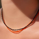 Two shimmering slim gemstone beaded necklace made of 2mm faceted stones layered together in carnelian and black spinel on a gold linking lobster clasp. 