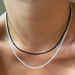 Two shimmering slim gemstone beaded necklace made of 2mm faceted stones layered together in moonstone and black spinel on a gold linking lobster clasp. 