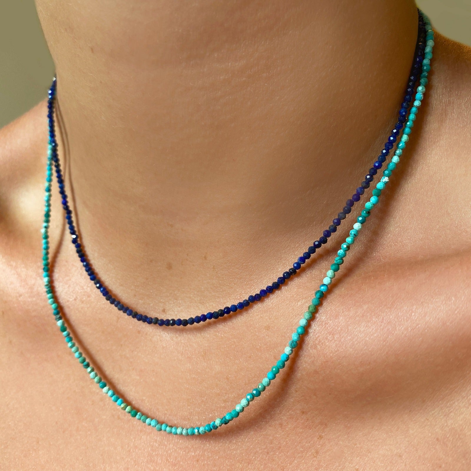 Two shimmering beaded necklaces made of 2mm faceted opals in shades of blue and turquoise on a gold linking lobster clasp.