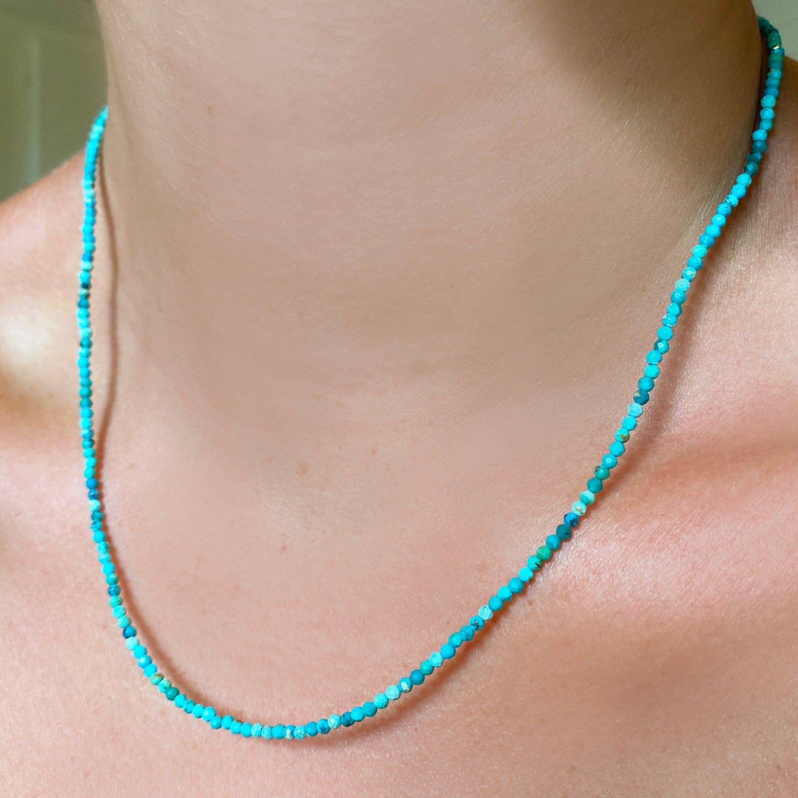 Shimmering beaded necklace made of 2mm faceted opals in shades of turquoise on a gold linking lobster clasp.